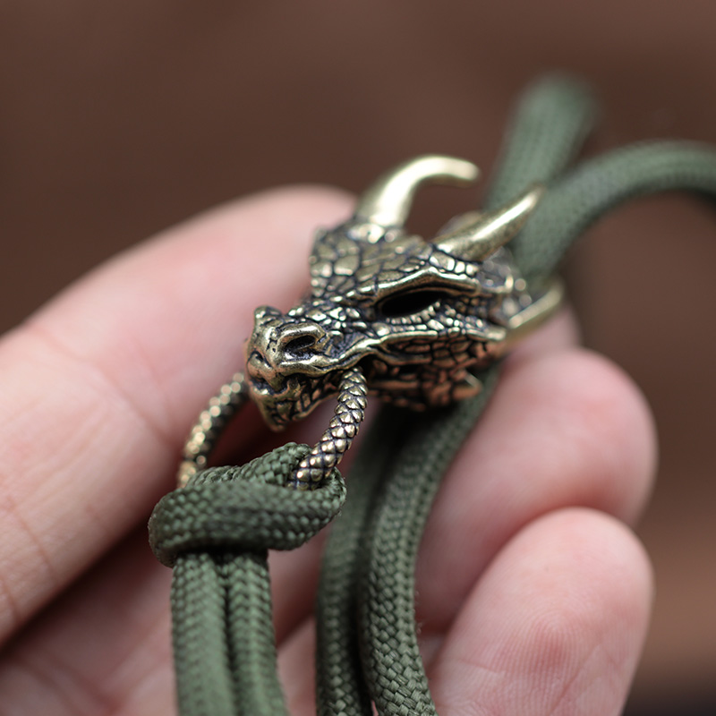 رأس التنين النحاس مشبك EDC في  - مراجعة Paracord Survival Bracelet وسعره